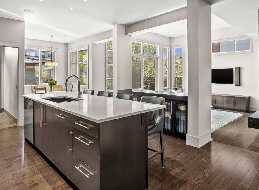 This stunning modern kitchen boasts a sleek design with a large island, perfect for meal preparation and entertaining.