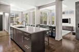 This stunning modern kitchen boasts a sleek design with a large island, perfect for meal preparation and entertaining.