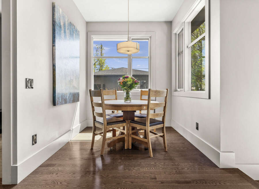 This stunning dining area features a round wooden table, perfect for intimate gatherings.