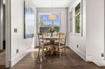 This stunning dining area features a round wooden table, perfect for intimate gatherings.