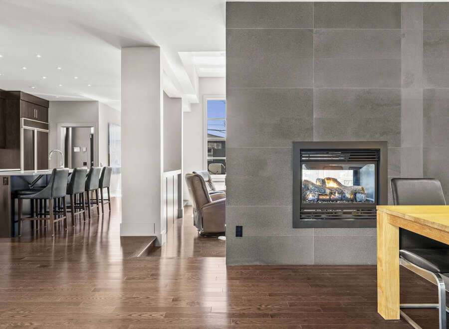 Experience luxury living in this stunning property featuring a modern kitchen with sleek cabinetry and a breakfast bar.