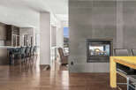 Experience luxury living in this stunning property featuring a modern kitchen with sleek cabinetry and a breakfast bar.