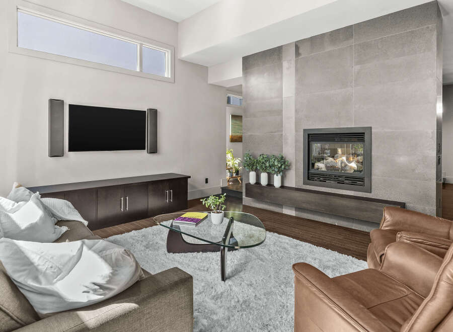 Step into luxury with this stunning living room featuring a modern fireplace and sleek built-in cabinetry.