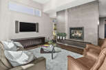 Step into luxury with this stunning living room featuring a modern fireplace and sleek built-in cabinetry.