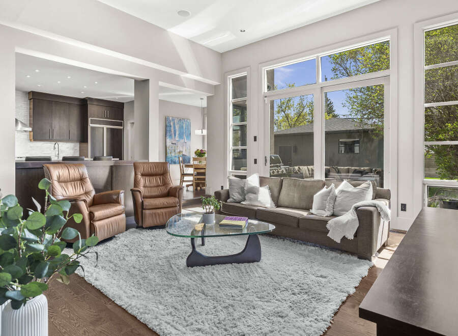 Step into luxury with this stunning living space, boasting an open-concept design that seamlessly connects the kitchen and living areas.