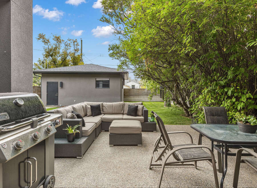 Enjoy outdoor living at its finest with this stunning property! This backyard oasis features a modern patio with comfortable seating, perfect for entertaining or relaxing.