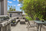 Enjoy outdoor living at its finest with this stunning property! This backyard oasis features a modern patio with comfortable seating, perfect for entertaining or relaxing.