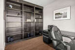 This stunning home office features a custom built-in bookshelf, perfect for displaying books and decor.