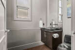 Step into this modern bathroom, featuring a stylish vanity with a unique stone sink.