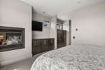 This stunning bedroom boasts a modern design with a cozy fireplace, perfect for relaxing evenings.