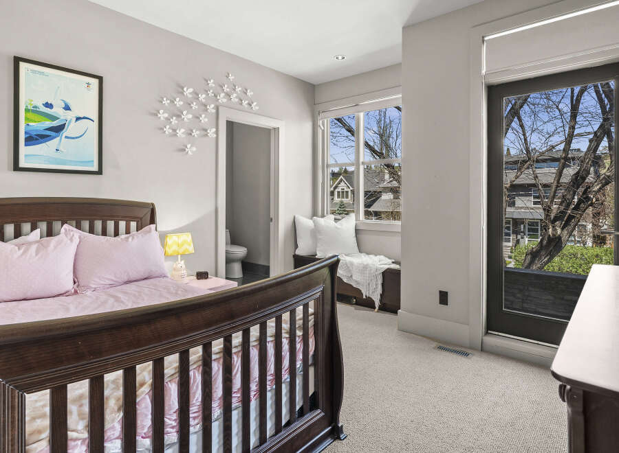 This charming bedroom features a cozy crib, perfect for a nursery or a child's room.