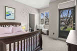 This charming bedroom features a cozy crib, perfect for a nursery or a child's room.