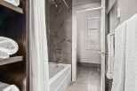 Step into a modern bathroom oasis! This space features a sleek bathtub, perfect for unwinding after a long day.