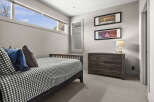 This inviting bedroom features a stylish bed with a checkered pattern, creating a cozy atmosphere.