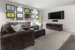 This stunning living room boasts a modern design with a comfortable sectional sofa, perfect for relaxing and entertaining.