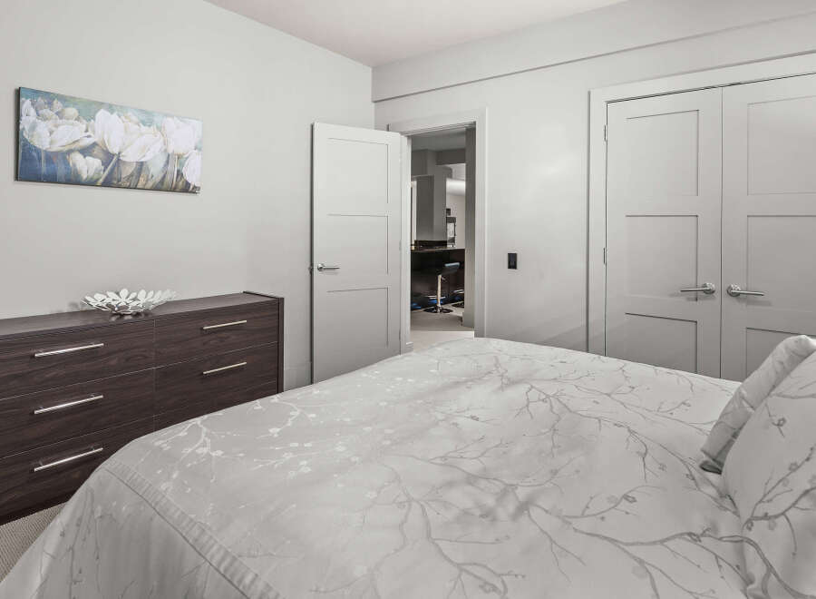 This modern bedroom offers a serene retreat with its neutral color palette and elegant design.