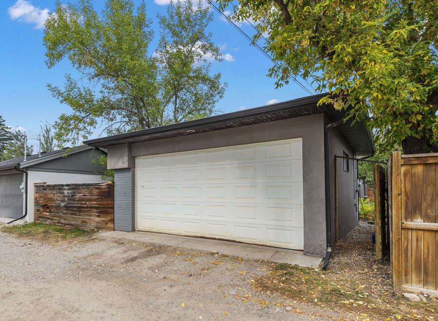 This property features a detached garage with a white garage door, perfect for parking and storage.