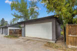This property features a detached garage with a white garage door, perfect for parking and storage.