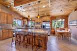 This stunning kitchen boasts a rustic charm with its wooden cabinetry, island, and ceiling.