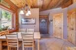 Step into this charming home featuring a cozy dining area with a wooden table and chairs, perfect for family gatherings.