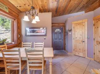 Step into this charming home featuring a cozy dining area with a wooden table and chairs, perfect for family gatherings.