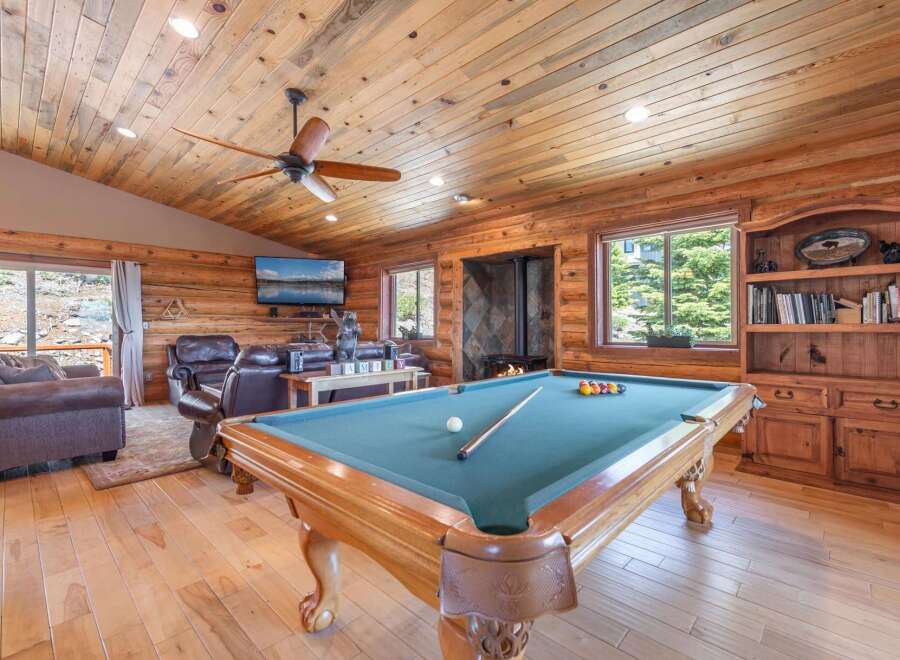 Step into luxury with this stunning property featuring a game room with a pool table, perfect for entertaining.