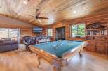 Step into luxury with this stunning property featuring a game room with a pool table, perfect for entertaining.