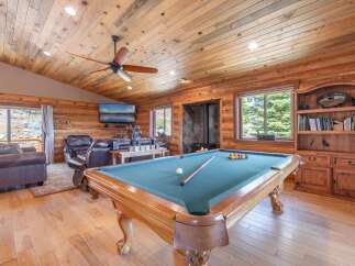 Step into luxury with this stunning property featuring a game room with a pool table, perfect for entertaining.