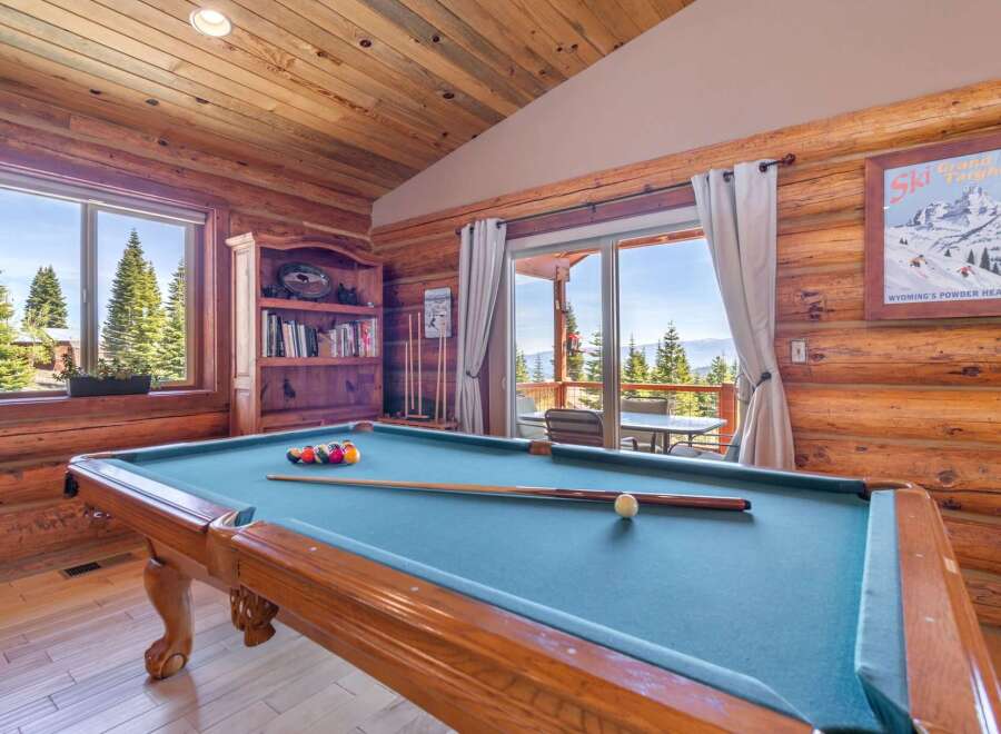 Step into luxury with this stunning property featuring a game room with a pool table, perfect for entertaining.