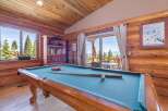 Step into luxury with this stunning property featuring a game room with a pool table, perfect for entertaining.