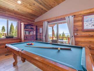 Step into luxury with this stunning property featuring a game room with a pool table, perfect for entertaining.