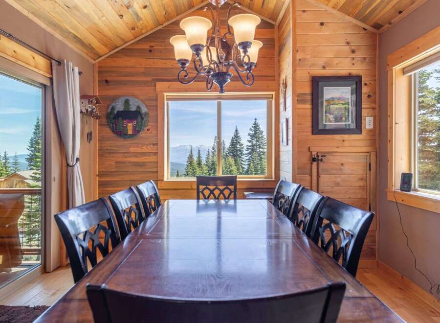 Step into a dining room that seamlessly blends rustic charm with breathtaking views.