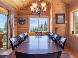 Step into a dining room that seamlessly blends rustic charm with breathtaking views.