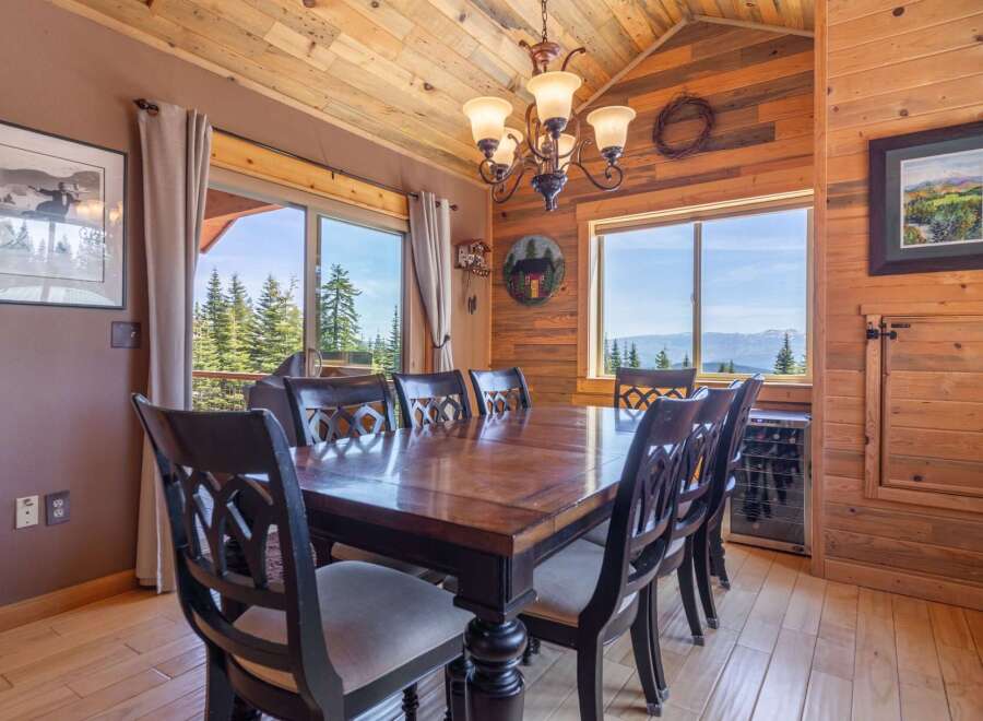 Step into this stunning dining room, featuring a beautiful wooden table and chairs, perfect for hosting memorable gatherings.