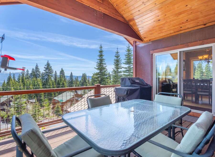 Enjoy breathtaking mountain views from this stunning property! This home features a spacious deck with a glass-top table, perfect for outdoor dining and relaxation.