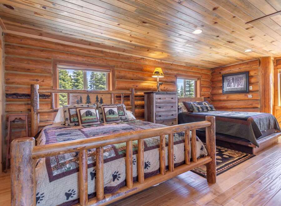 Step into rustic elegance in this stunning log cabin bedroom.