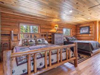 Step into rustic elegance in this stunning log cabin bedroom.