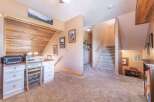 Step into this inviting home featuring a cozy workspace with a charming desk and a unique wooden accent wall.