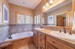 This beautiful bathroom features a luxurious soaking tub and a stylish vanity with dual sinks.