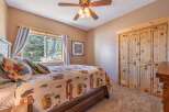 This cozy bedroom features a rustic wooden bed frame and a charming quilt, creating a warm and inviting atmosphere.