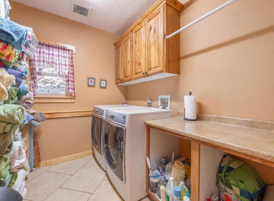 This laundry room offers a functional and stylish space for your laundry needs.
