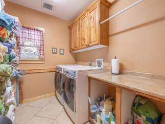 This laundry room offers a functional and stylish space for your laundry needs.
