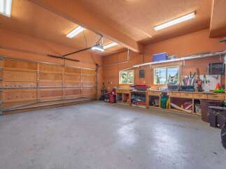 This spacious garage offers ample room for vehicles and storage, perfect for car enthusiasts or those needing extra space.