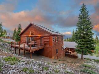 Nestled in a serene mountain setting, this stunning log cabin offers a perfect blend of rustic charm and modern comfort.