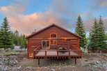 Nestled amidst the serene beauty of nature, this charming cabin offers a perfect blend of rustic elegance and modern comfort.