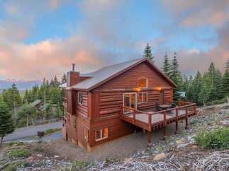 Nestled amidst a serene mountain landscape, this stunning cabin offers a perfect blend of rustic charm and modern comfort.
