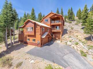 Nestled in a serene mountain setting, this stunning log cabin offers a perfect blend of rustic charm and modern comfort.