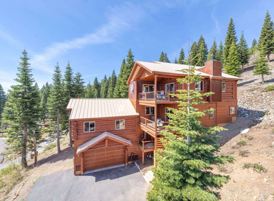 Nestled amidst towering pines, this stunning mountain home offers a serene escape.