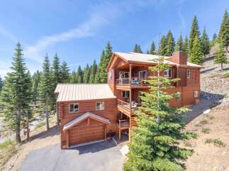 Nestled amidst towering pines, this stunning mountain home offers a serene escape.
