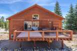Discover the charm of this stunning cabin, boasting a spacious deck perfect for outdoor relaxation and entertaining.